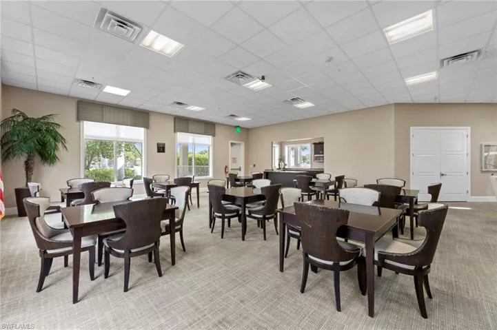 Dining room featuring light carpet and a drop ceiling