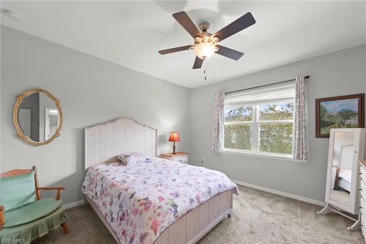 Bedroom featuring carpet and ceiling fan