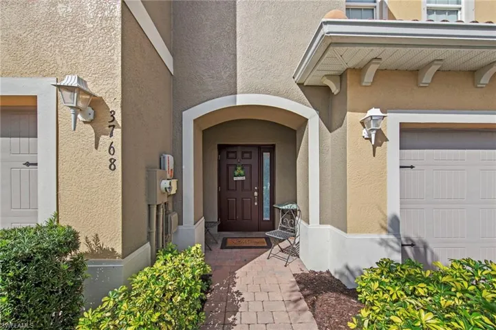 Doorway to property with stucco siding