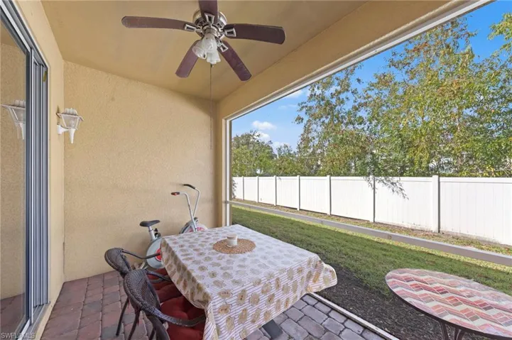 Sunroom featuring a ceiling fan, outdoor dining area, and a patio area