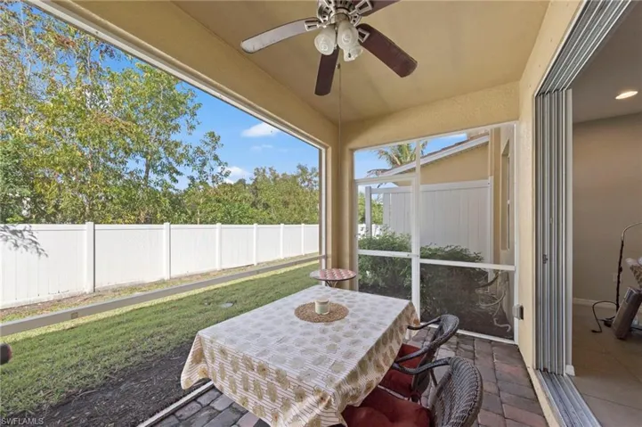 Sunroom / solarium featuring ceiling fan and outdoor dining area