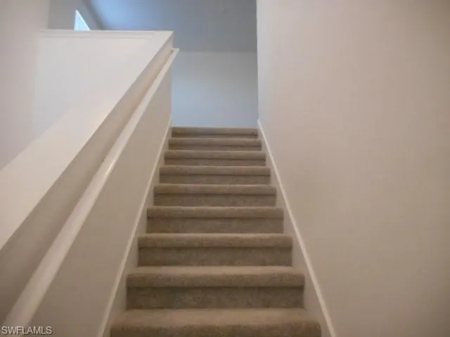 Stairway featuring baseboards