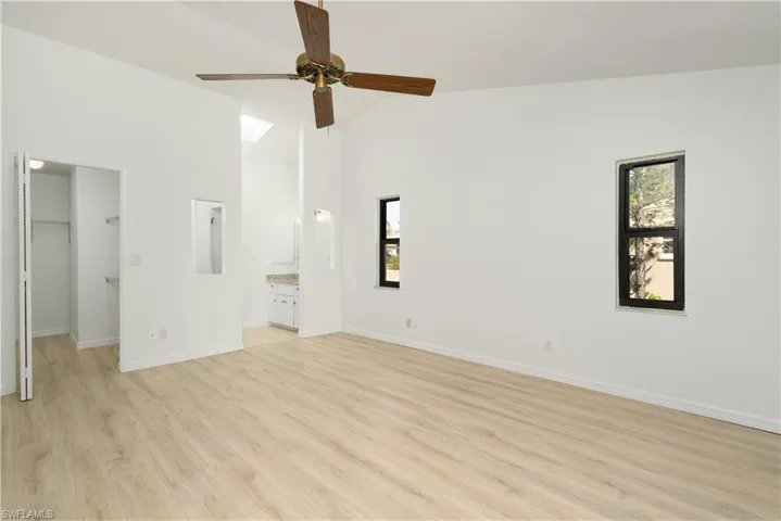 Primary Bedroom with Pergo flooring, walk in closet and en-suite Bathroom. Freshly painted interior.