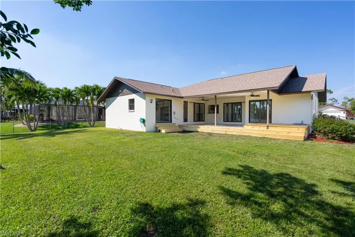 Back of property with ceiling fans. Fenced in area. Great area to enjoy the backyard. Big enough to add a pool.