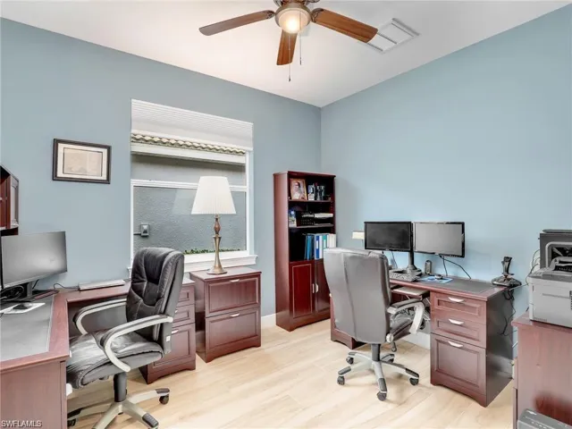 Office area featuring ceiling fan and light wood-type flooring