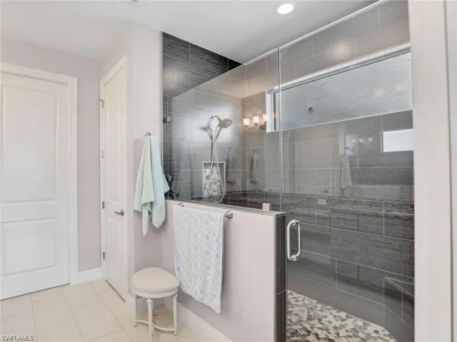 Bathroom featuring tile patterned flooring and an enclosed shower