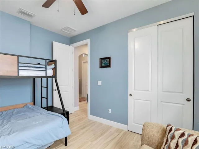 Bedroom featuring ceiling fan and a closet