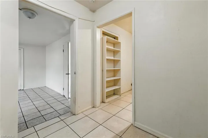 Hall featuring tile patterned floors