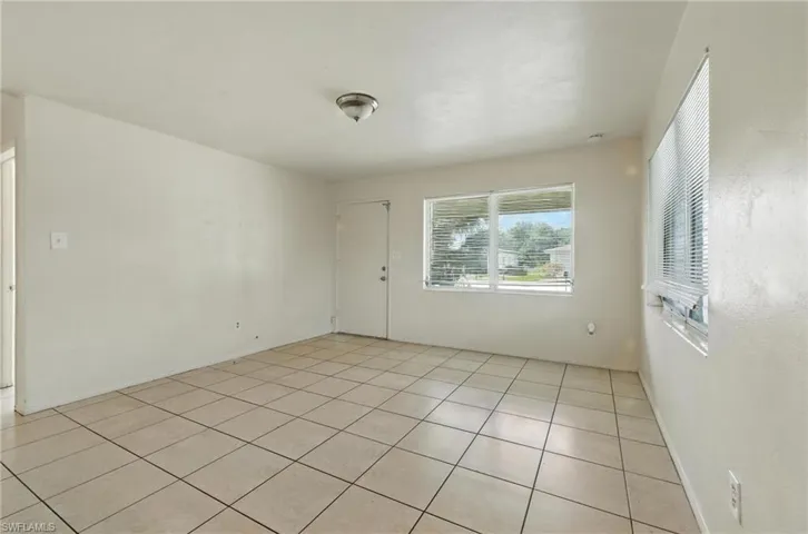 Unfurnished room featuring light tile patterned floors