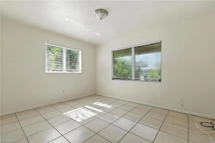 Spare room featuring healthy amount of natural light and light tile patterned floors