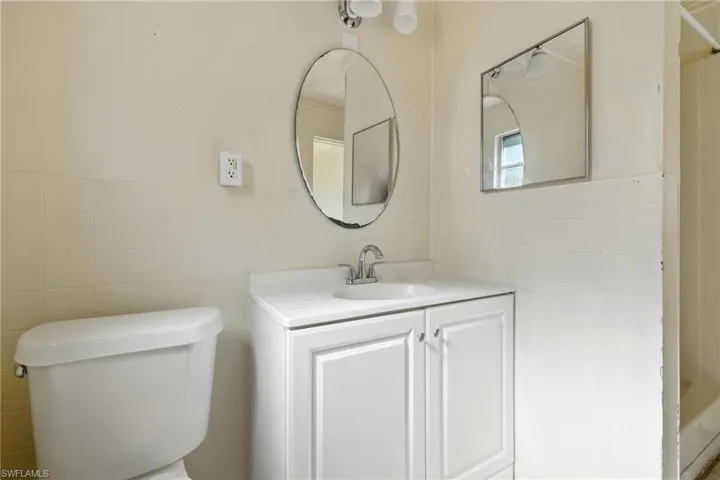 Bathroom featuring tile walls and vanity