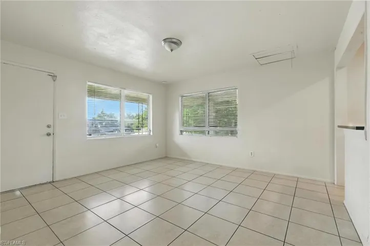 Unfurnished room featuring light tile patterned floors