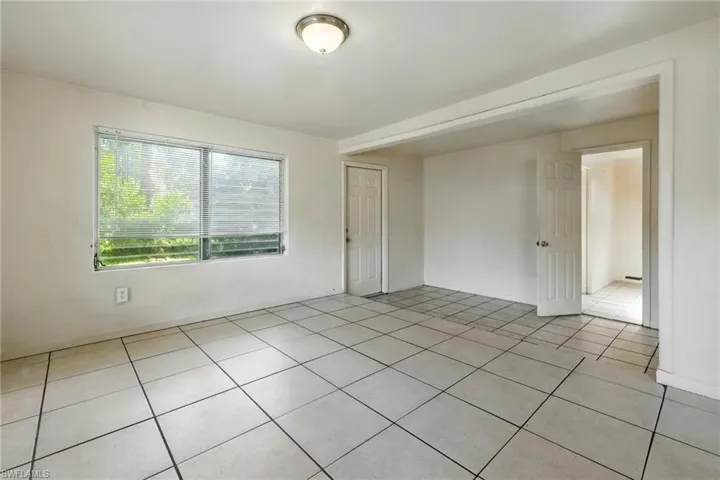 Unfurnished room featuring light tile patterned floors