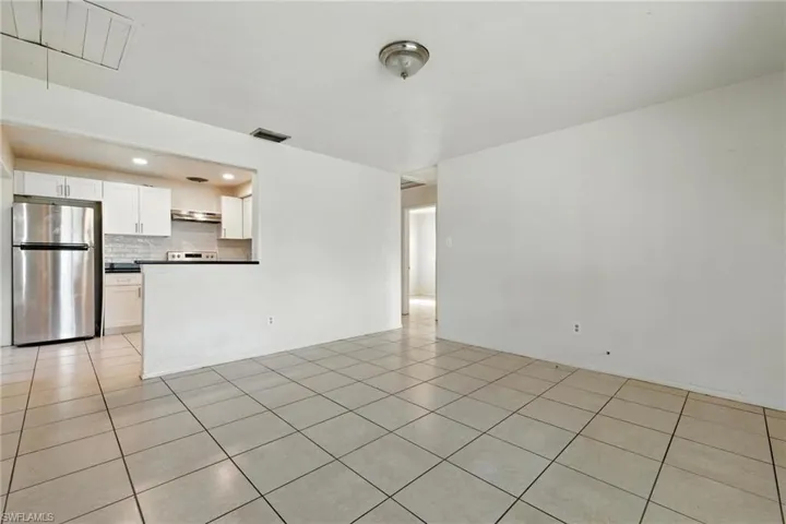 Unfurnished living room featuring light tile patterned floors and recessed lighting