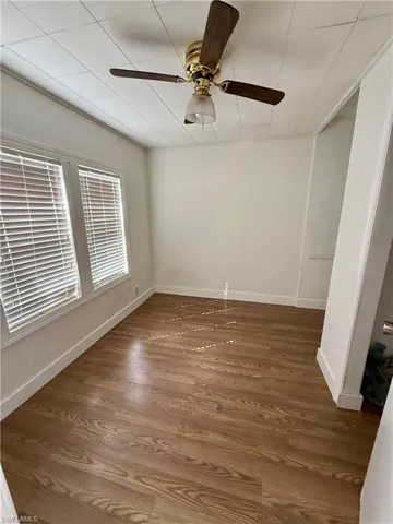 Empty room with wood finished floors and ceiling fan