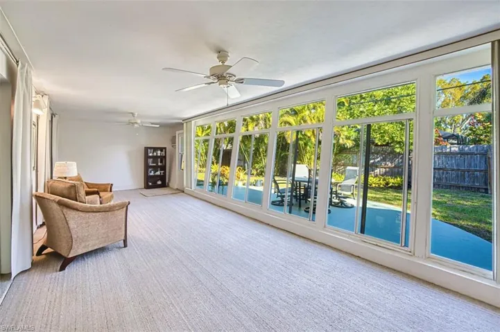 View of sunroom with large slanted windows almost the length of the home.