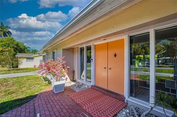 Property entrance with a patio and stucco siding