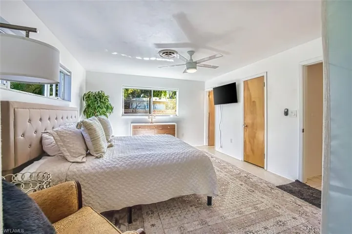 Bedroom with ceiling fan and a closet