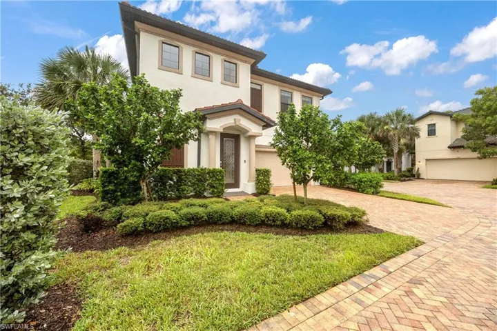 Mediterranean / spanish-style home featuring stucco siding, a garage, and decorative driveway