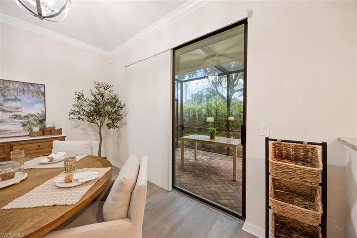 Dining room featuring light wood-style flooring and ornamental molding