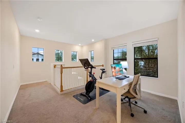 Carpeted home office featuring plenty of natural light and recessed lighting