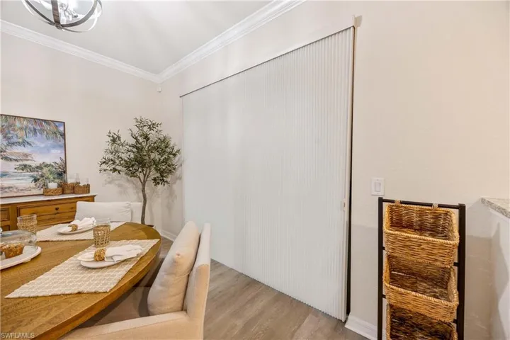 Dining space featuring light wood-style floors and crown molding