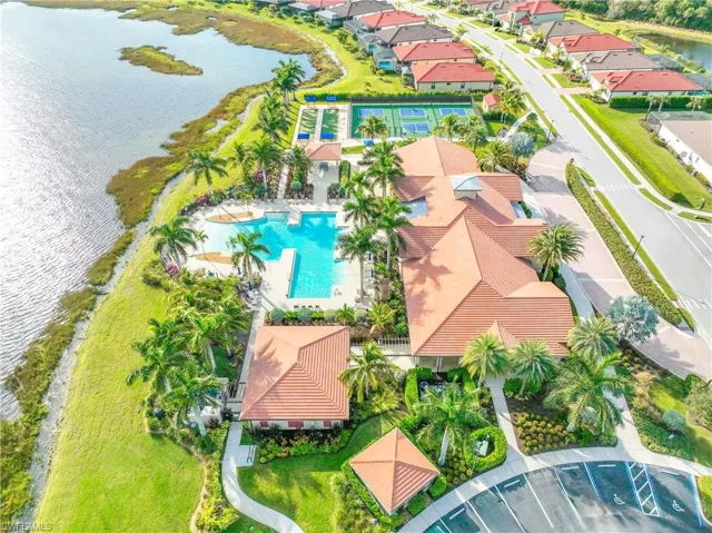 Aerial view of a pool area and a nearby body of water