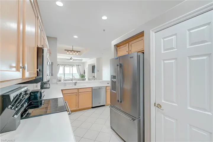 Kitchen featuring appliances with stainless steel finishes, light tile patterned flooring, recessed lighting, light countertops, and light brown cabinets