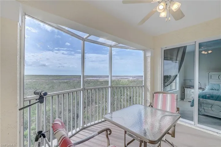 Sunroom / solarium featuring a balcony and a ceiling fan