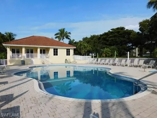 Community pool with a patio