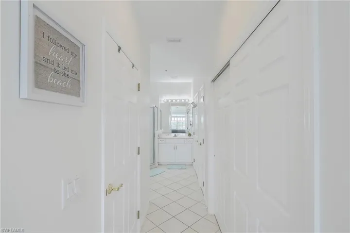 Hallway with light tile patterned flooring