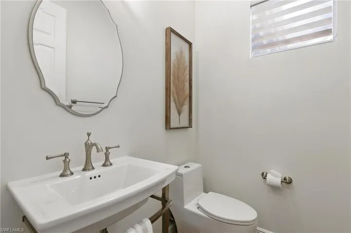 The powder room is located off the dining room at the front of the home