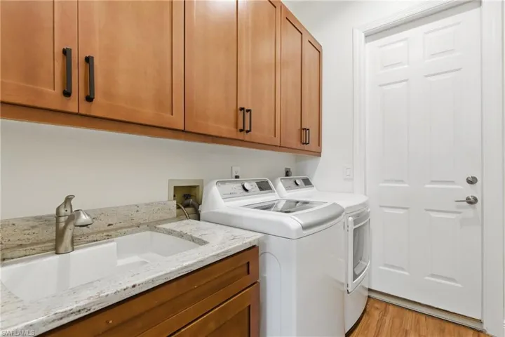 The utility room located just off the garage has plenty of storage, sink and extra cabinet space