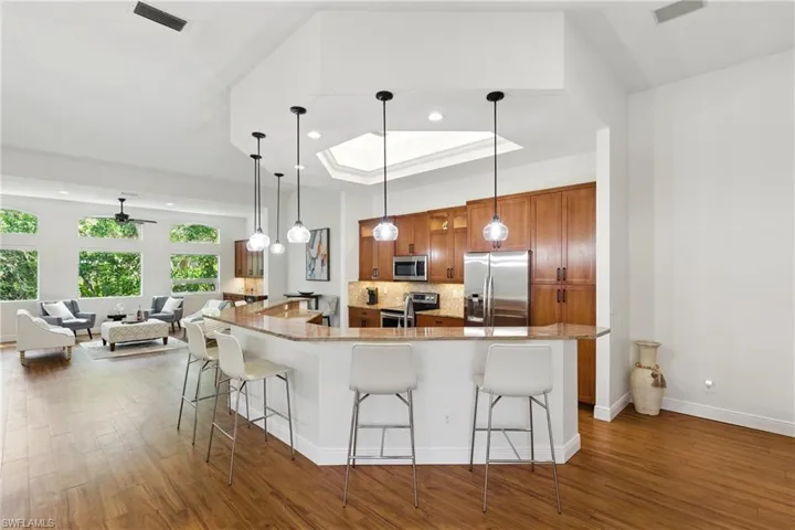 The great room flows between kitchen, dining, living, and family room spaces