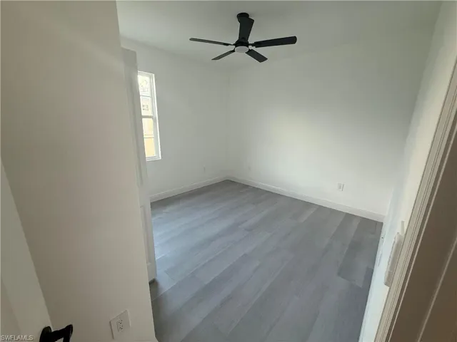 Spare room featuring ceiling fan and wood finished floors