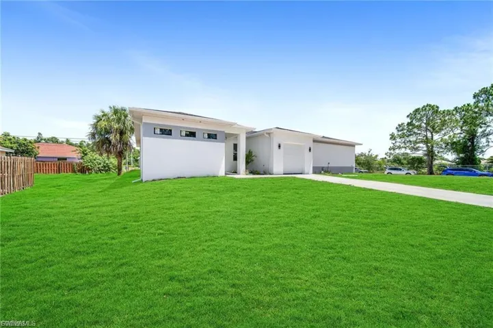 View of front of house featuring concrete driveway, a garage, and stucco siding