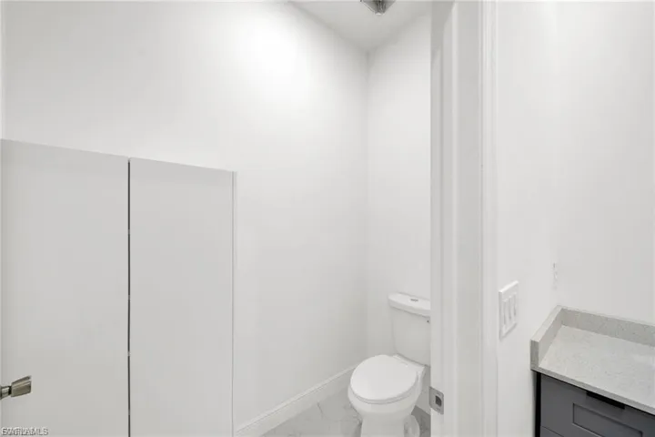 Bathroom with marble look tiles and vanity