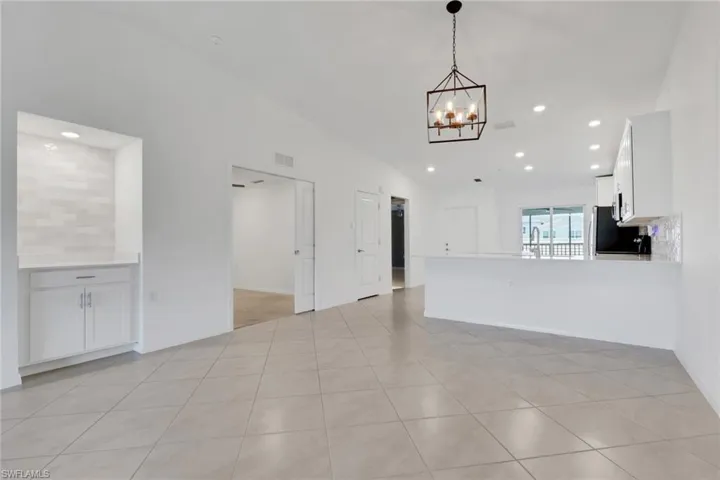 Living room, den, and dining room, with breakfast bar