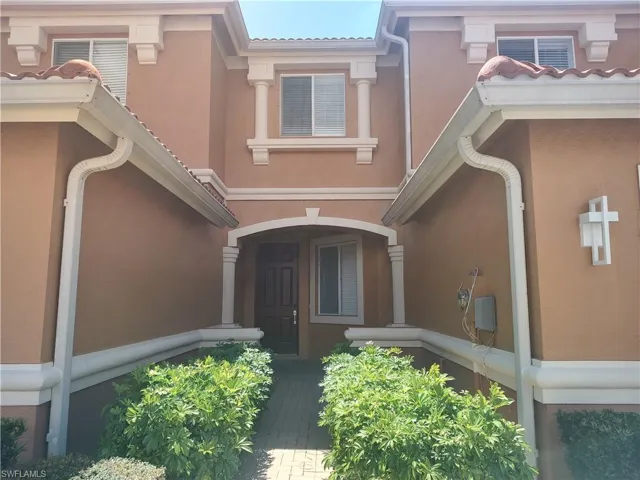 Doorway to property with stucco siding