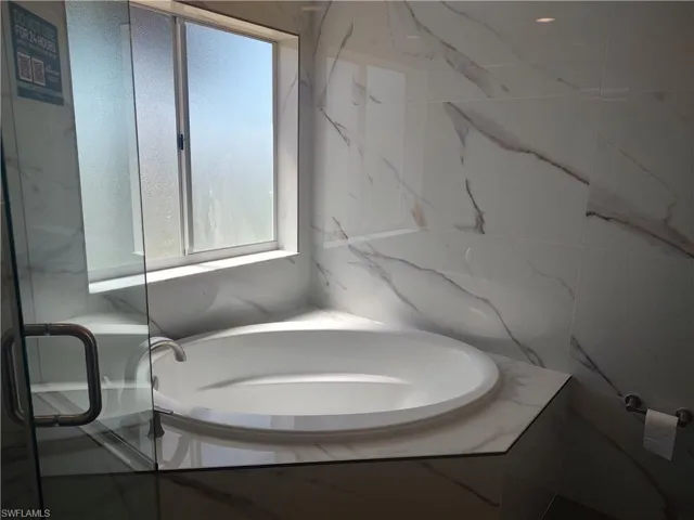Full bath featuring a garden tub for a relaxing soak