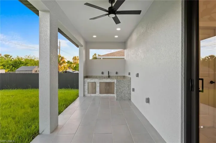 View of patio featuring an outdoor kitchen and ceiling fan