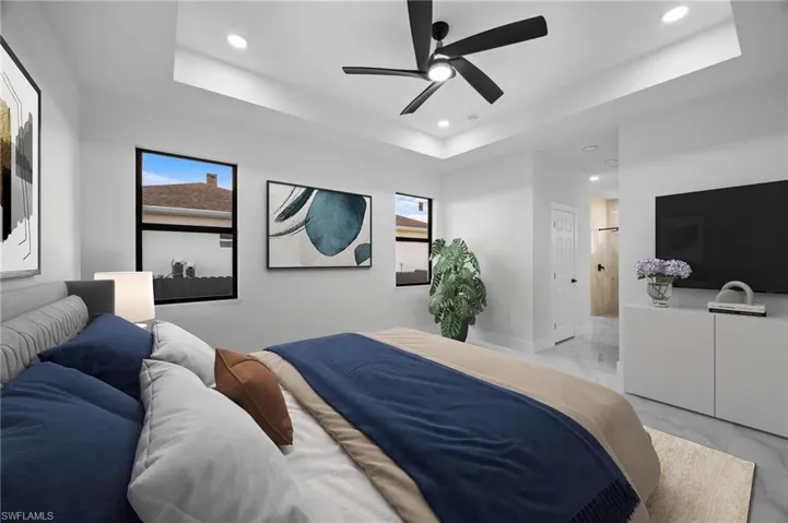 Virtual Staged Master Bedroom featuring recessed lighting, light marble finish flooring, a raised ceiling, a ceiling fan, and baseboards