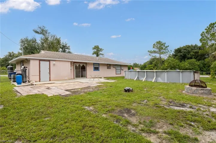 Back of property with a lawn