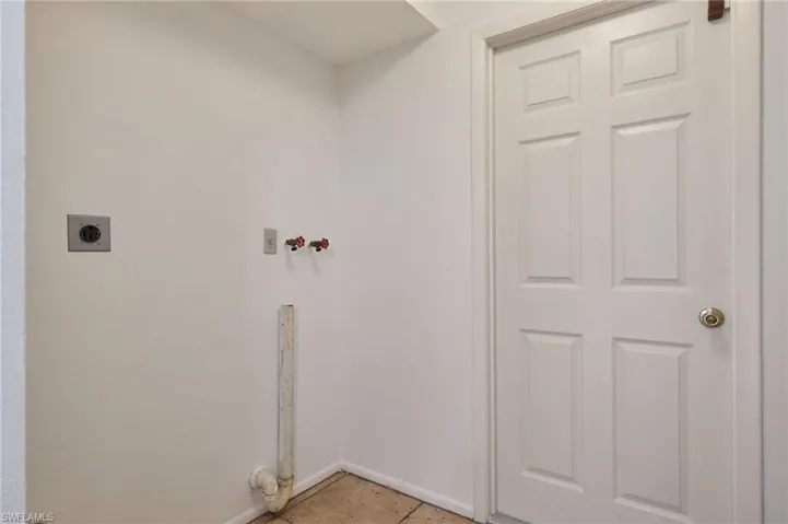 Laundry room featuring electric dryer hookup, washer hookup, and light tile patterned floors