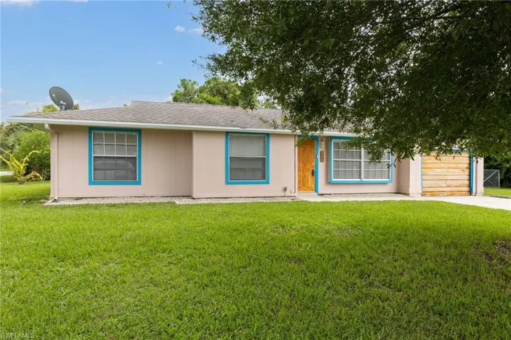 Ranch-style home with a front lawn