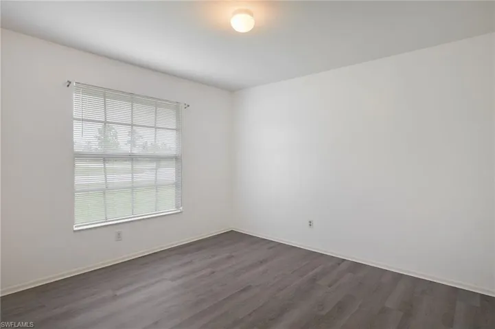 Empty room with hardwood / wood-style floors