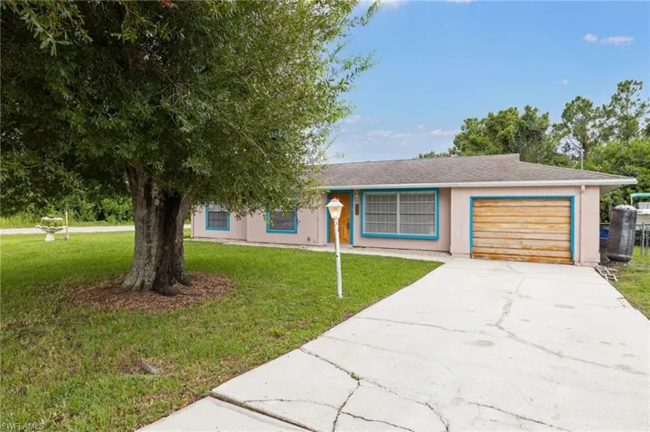View of front of property with a garage and a front yard