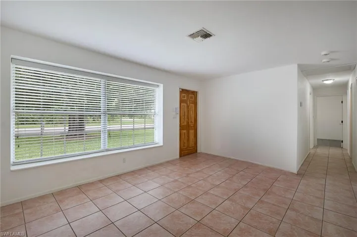 Tiled empty room featuring plenty of natural light