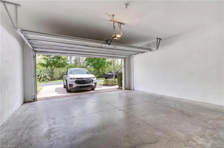 Spacious garage with concrete flooring and painted block walls