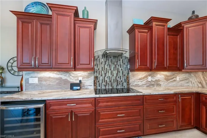 Kitchen features a wine cooler and exhaust fan